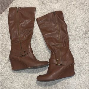 slightly worn brown high boots